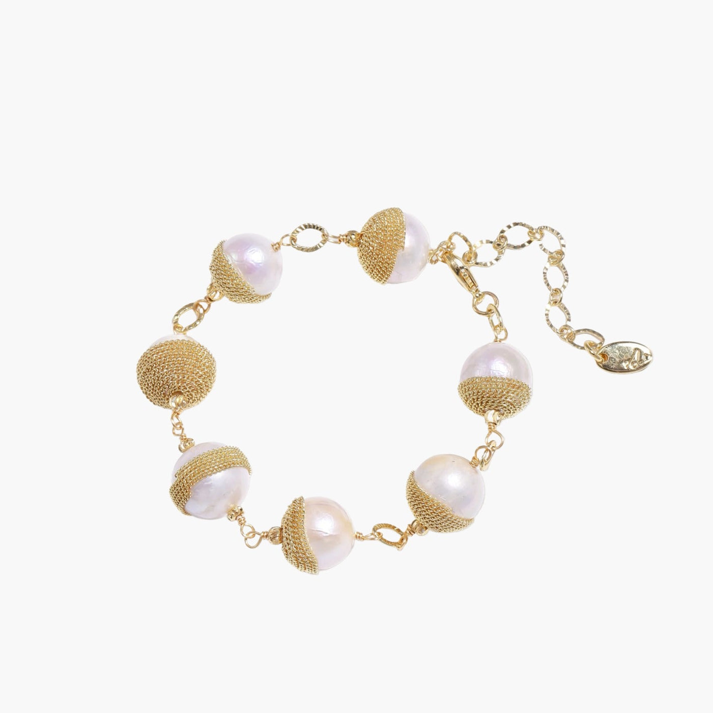 Adjustable bracelet with baroque pearls wrapped in delicate gold mesh netting connected by textured chain links